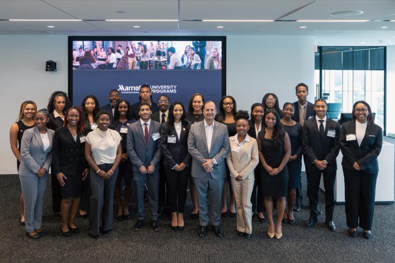 Howard University students pose at Marriott International headquarters with Anthony Capuano