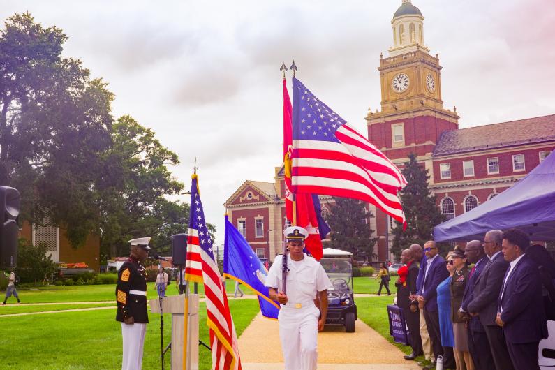 The Howard University Color Guard wearing military uniforms presenting the colors on The Yard