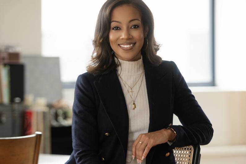 Jasmine Gurley seated wearing a white turtleneck and dark blazer