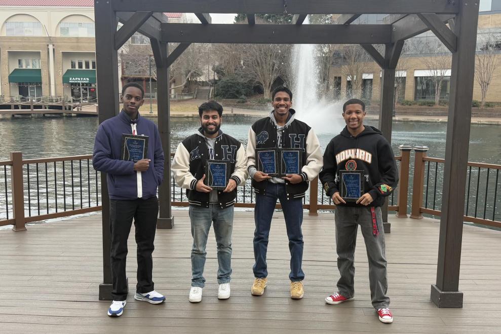 Howard University chess team pose with awards.