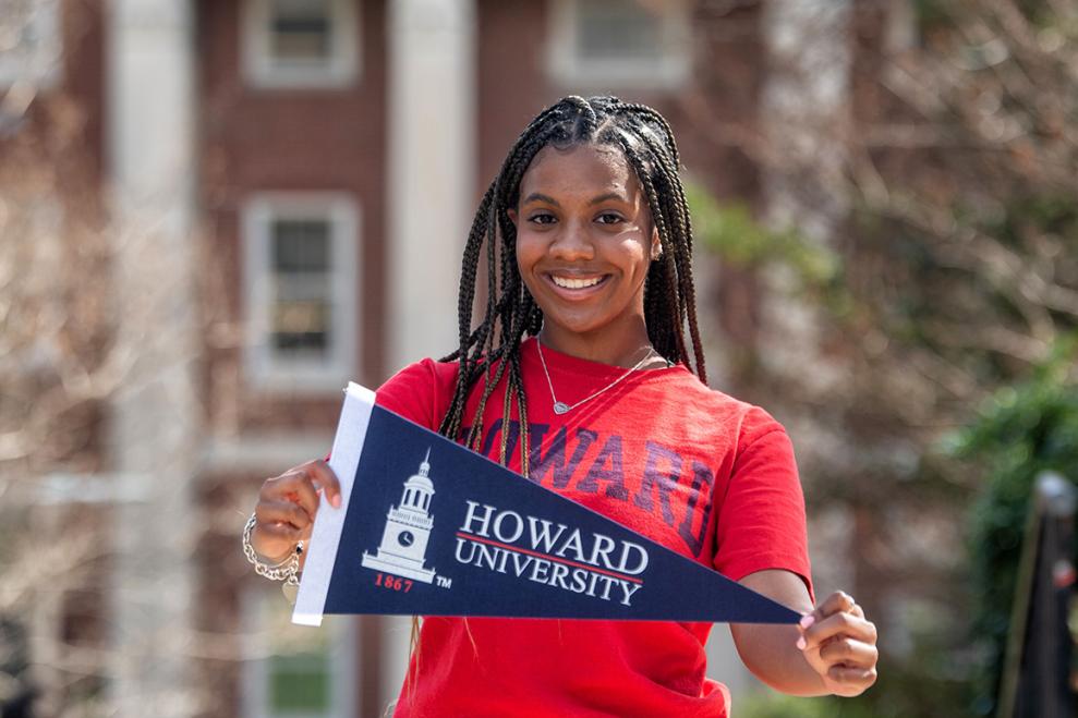 Howard student with a pennant