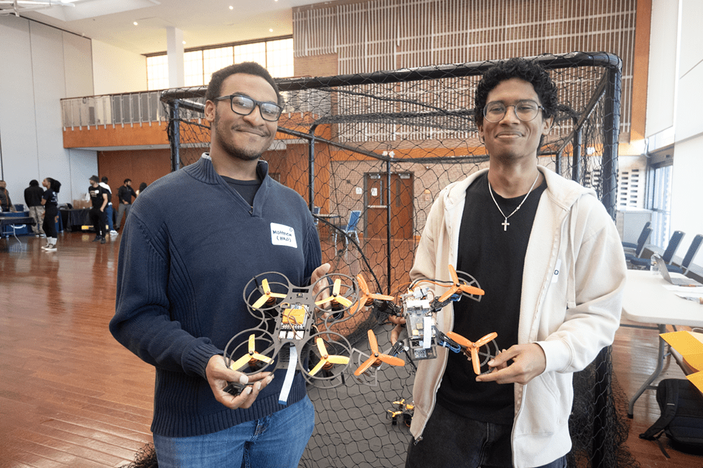 HURO Team Members Holding Drones at AI Event