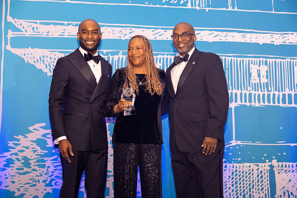 Sylvia Taylor accepting award from School of Business leadership