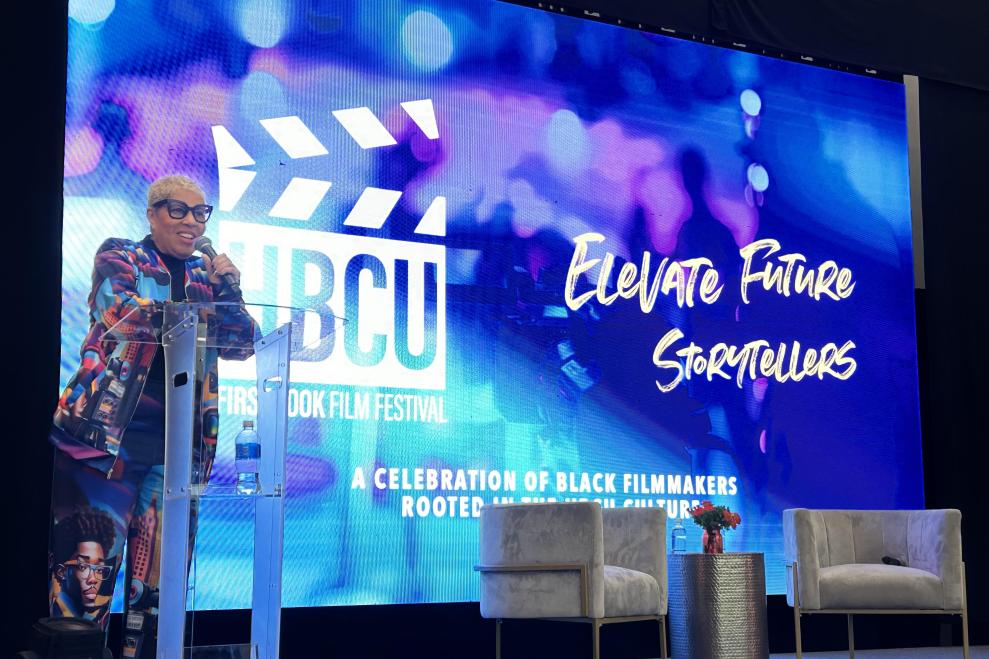 Shelia Eldridge on stage behind a clear podium