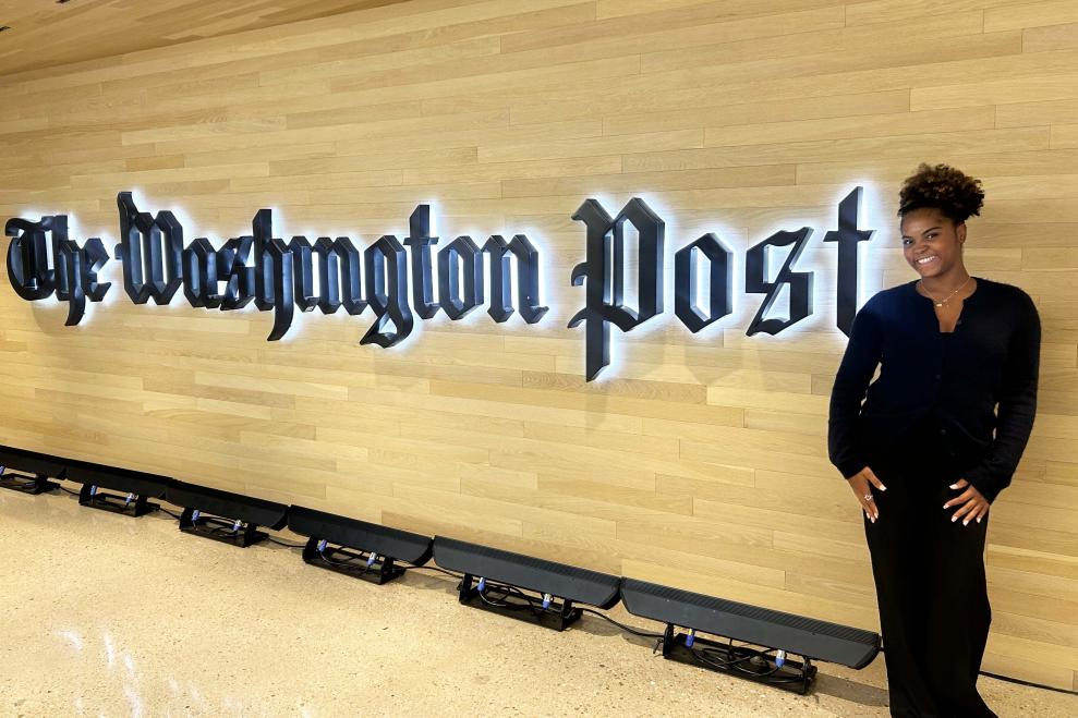 Zoe Cummings standing in front of the Washington Post sign