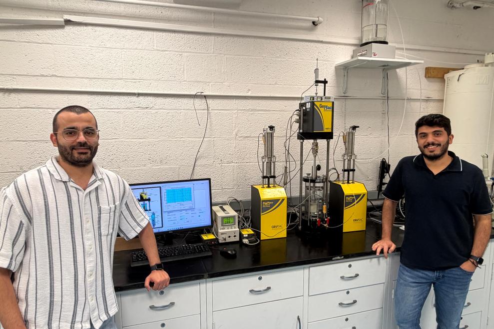 Jaradat at work in his Geomaterials Research Lab with Ph.D. student Mohammad Almasaeid