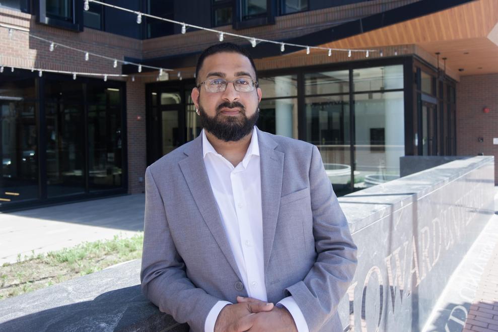 Bilal Badruddin standing in front of a Howard University building