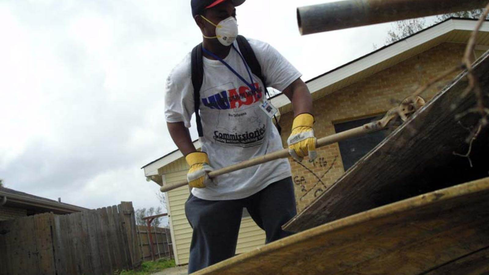 A Howard student helps a neighborhood dig out after Katrina in New Orleans.