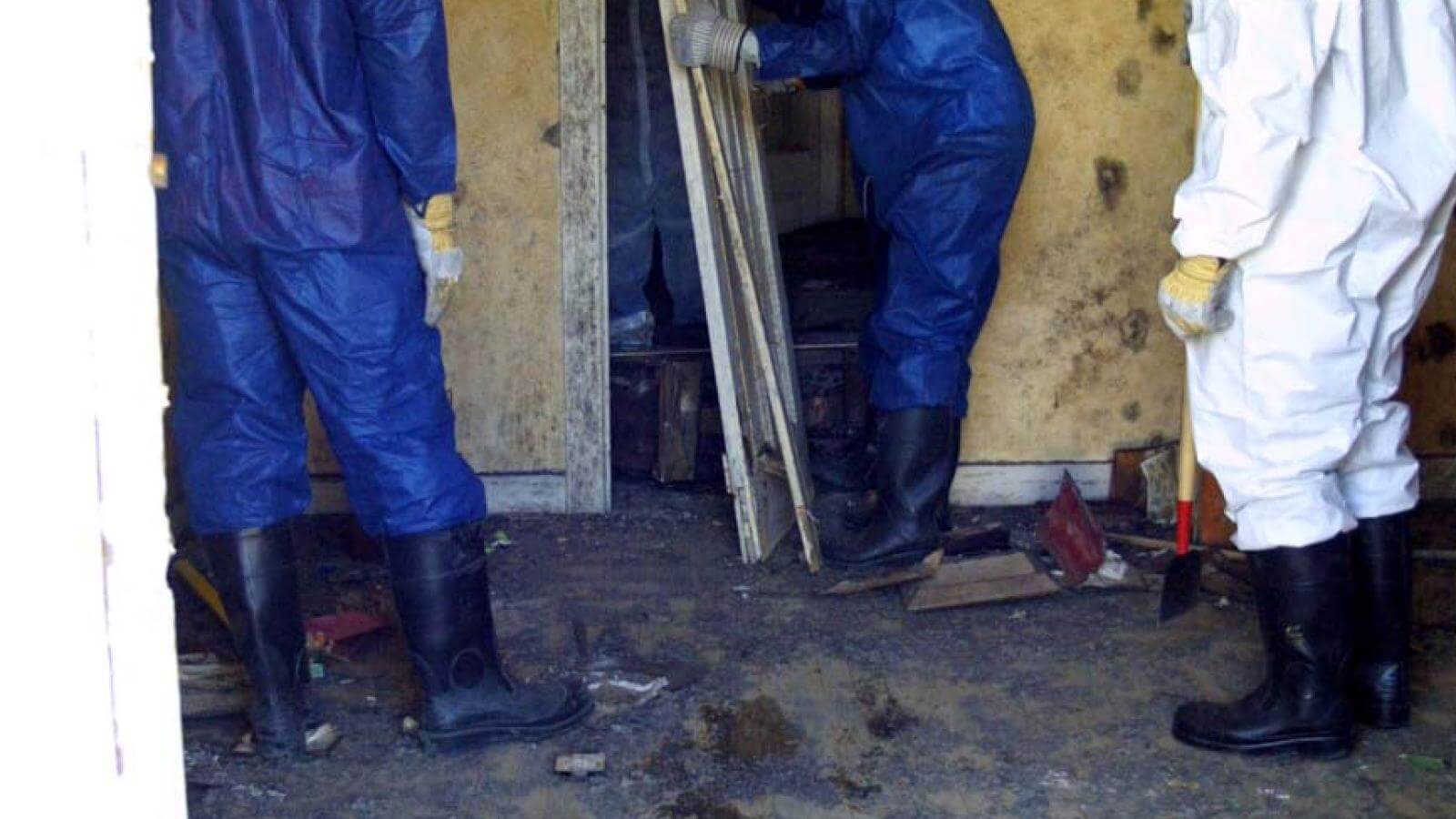 Students help empty a house damaged by Hurricane Katrina.