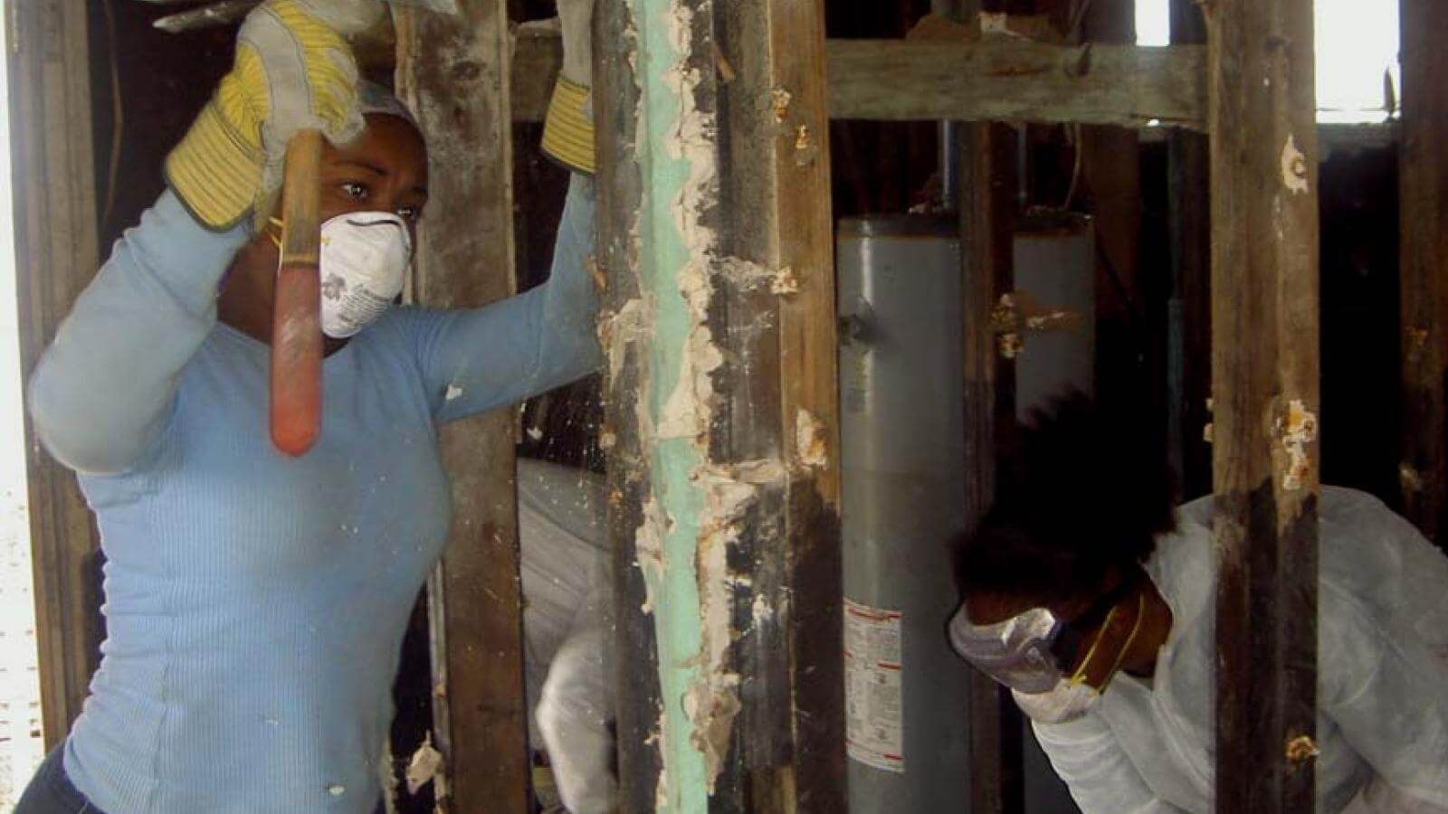 A Howard student helps clear a house damaged in Hurricane Katrina.
