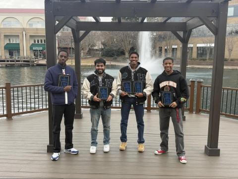 Howard University chess team pose with awards.