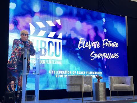 Shelia Eldridge on stage behind a clear podium