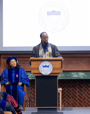 Dr. Ibram X. Kendi stands at a podium at Founder's Library at Howard University