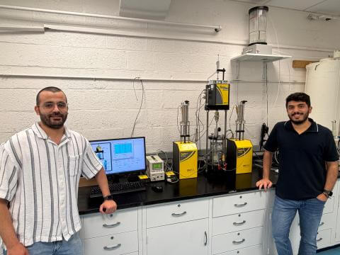 Jaradat at work in his Geomaterials Research Lab with Ph.D. student Mohammad Almasaeid