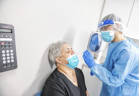seated patient receives a treatment from a doctor through nose
