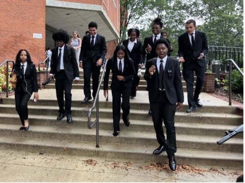 Students wearing black suits