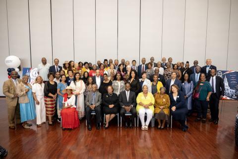 Howard University Retirees at the Retirement Celebration posed for a photo at the Retirement Celebration, in between Anthony Wutoh and Dr. Wayne A. I. Frederick at the Blackburn Center Ballroom