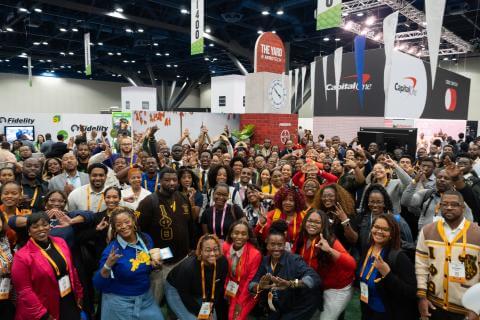 A group of Black technology professionals gather for a photo at The Yard at Afrotech activation in 2025