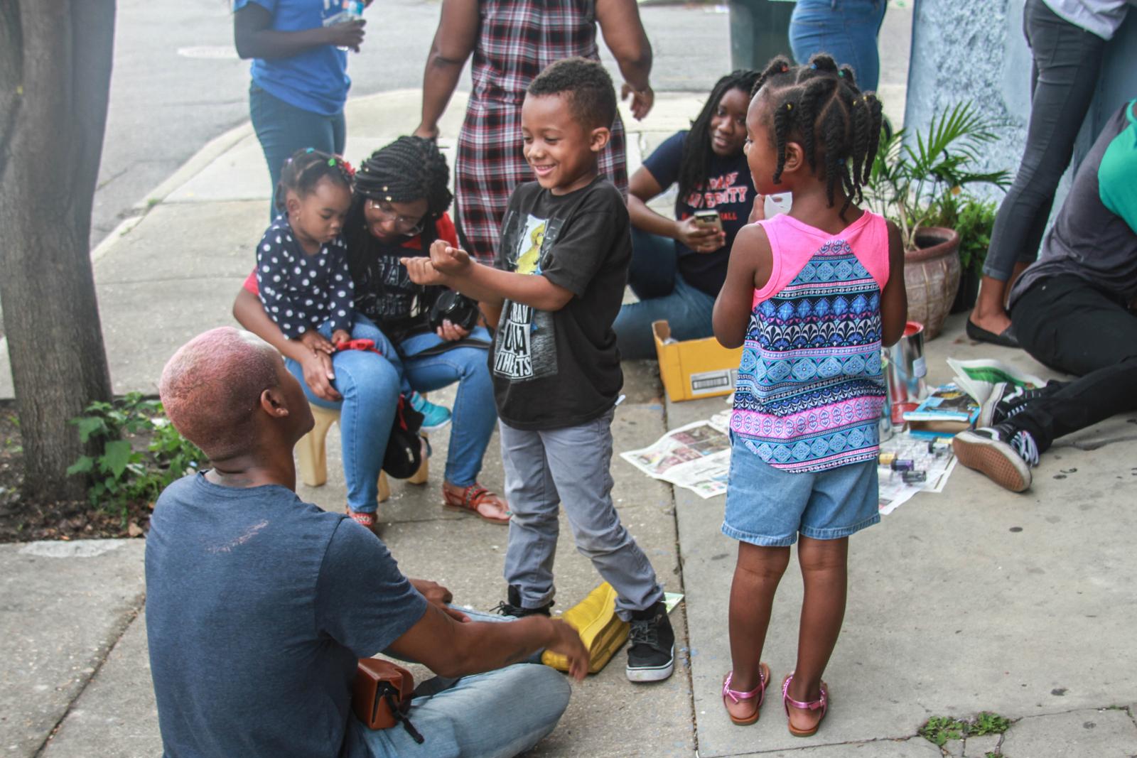 Volunteers with small children playing outside