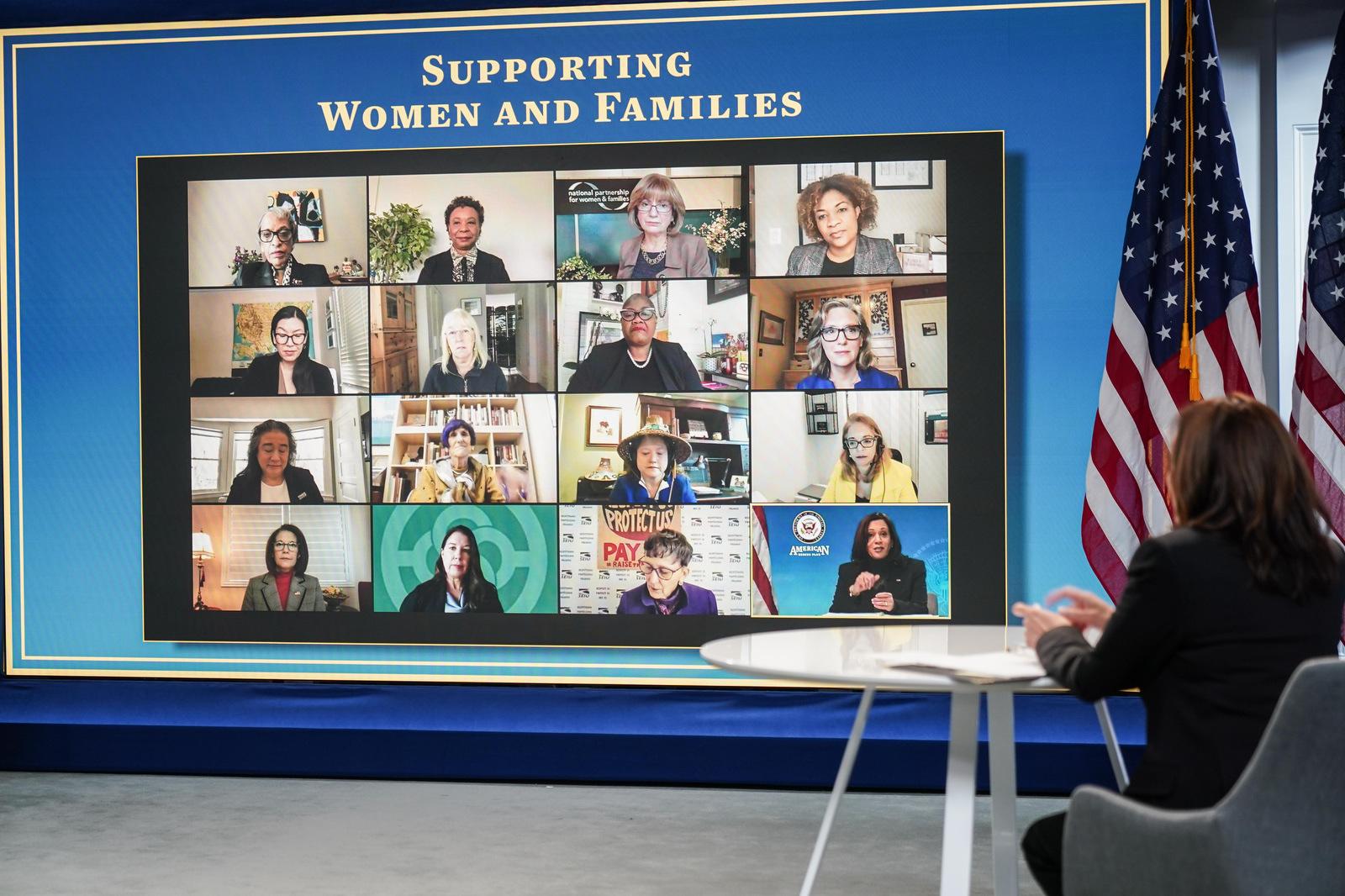 Kamala Harris sitting by large Zoom screen with grid of faces