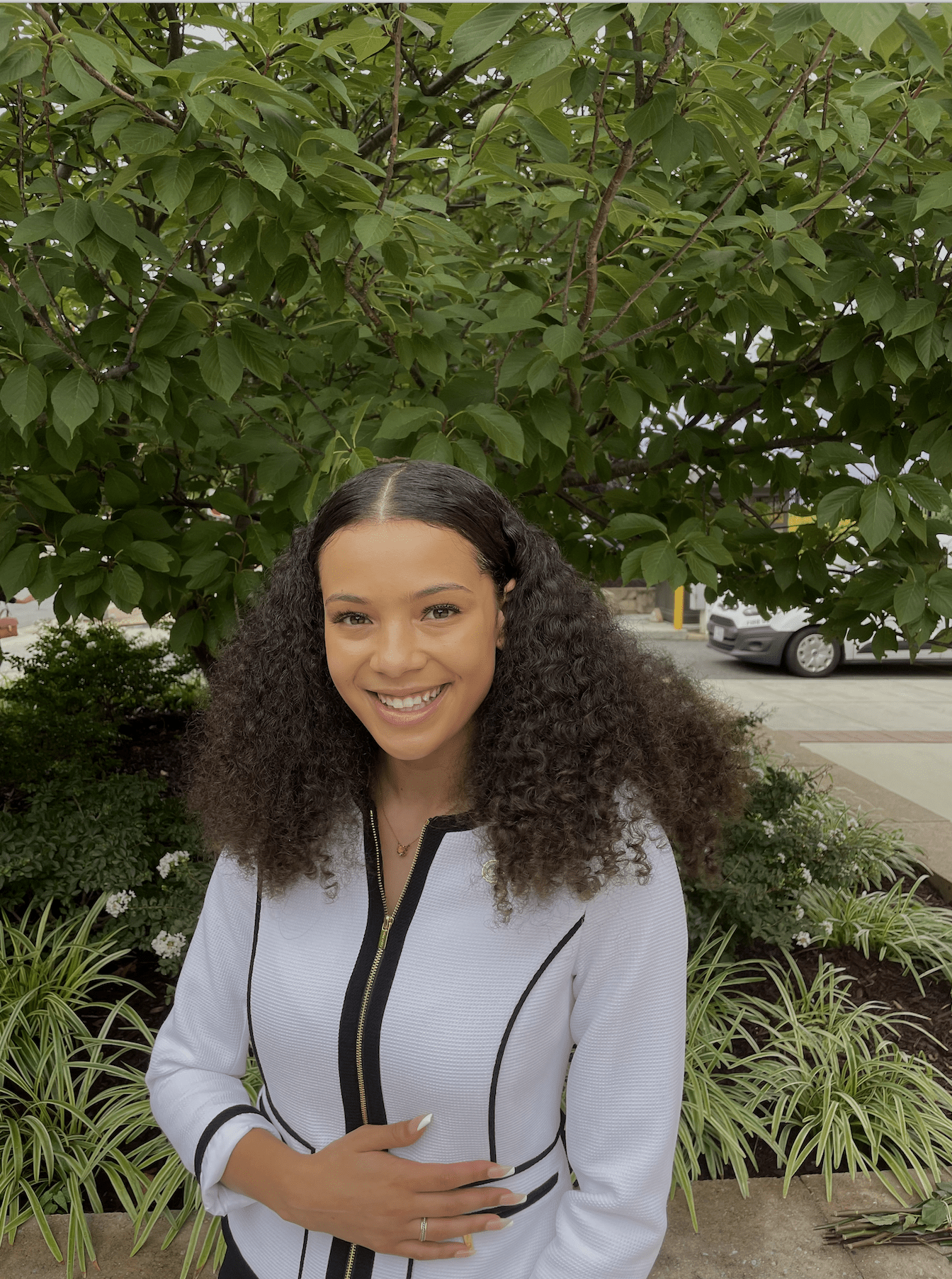 Kylie Burke headshot standing outside by trees