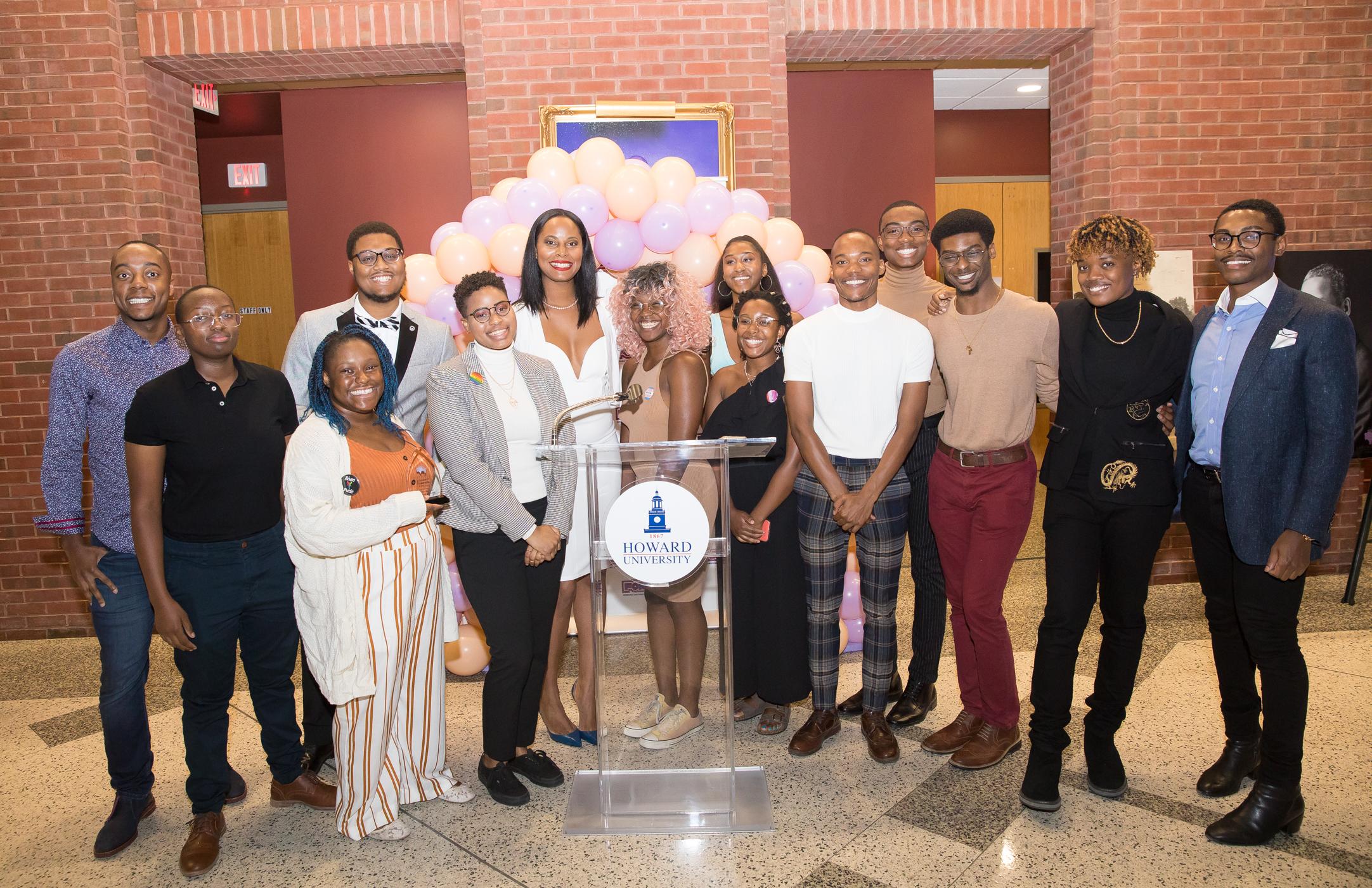 Recipients of Lavender scholarship stand by podium 