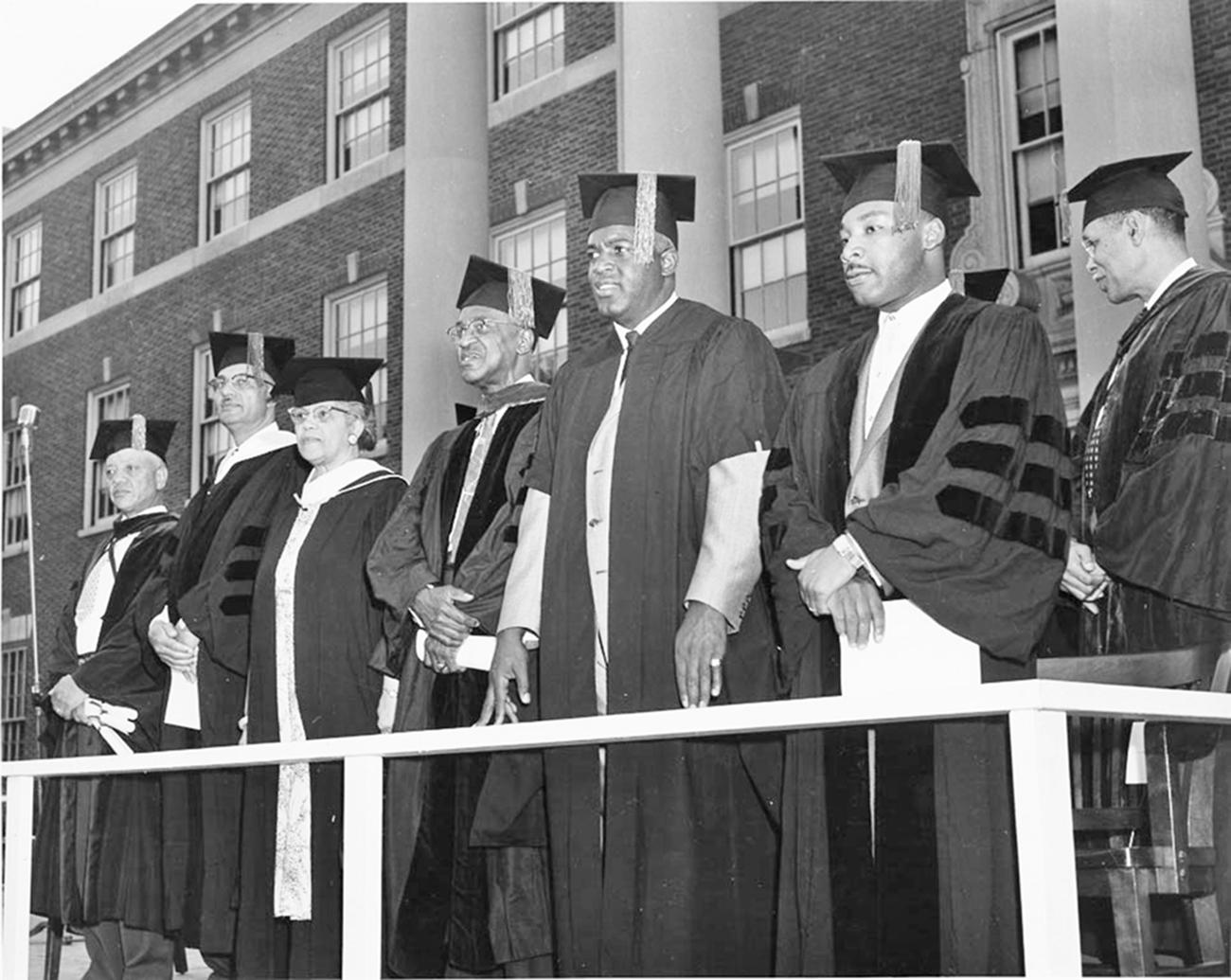 Martin Luther King Jr. and Jackie Robinson standing in graduation robes with other men receiving honorary degrees