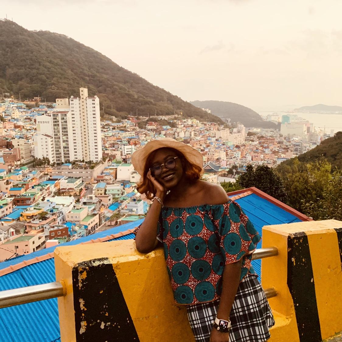 student standing with straw hat overlooking Rio