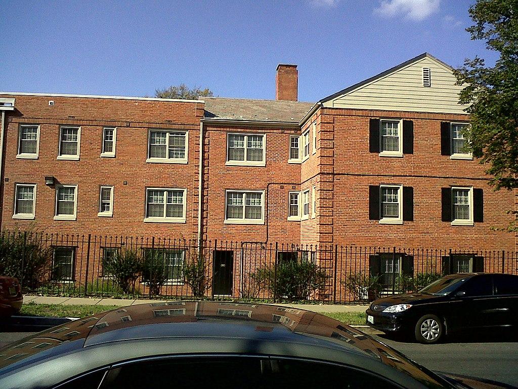 three-floor brick apartment complex