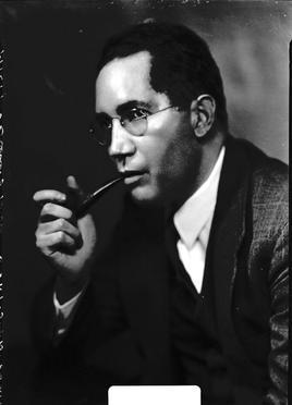 b/w photo of Sterling Brown smoking pipe