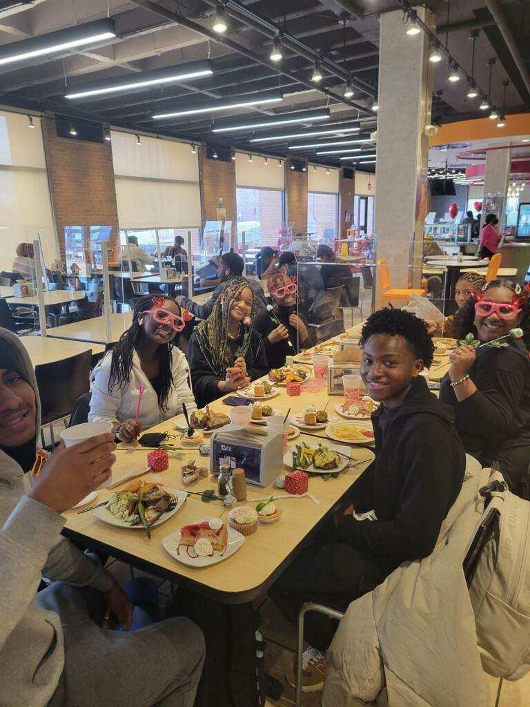 Students at cafeteria table for Valentine's Day dinner