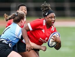 Howard female student playing rugby