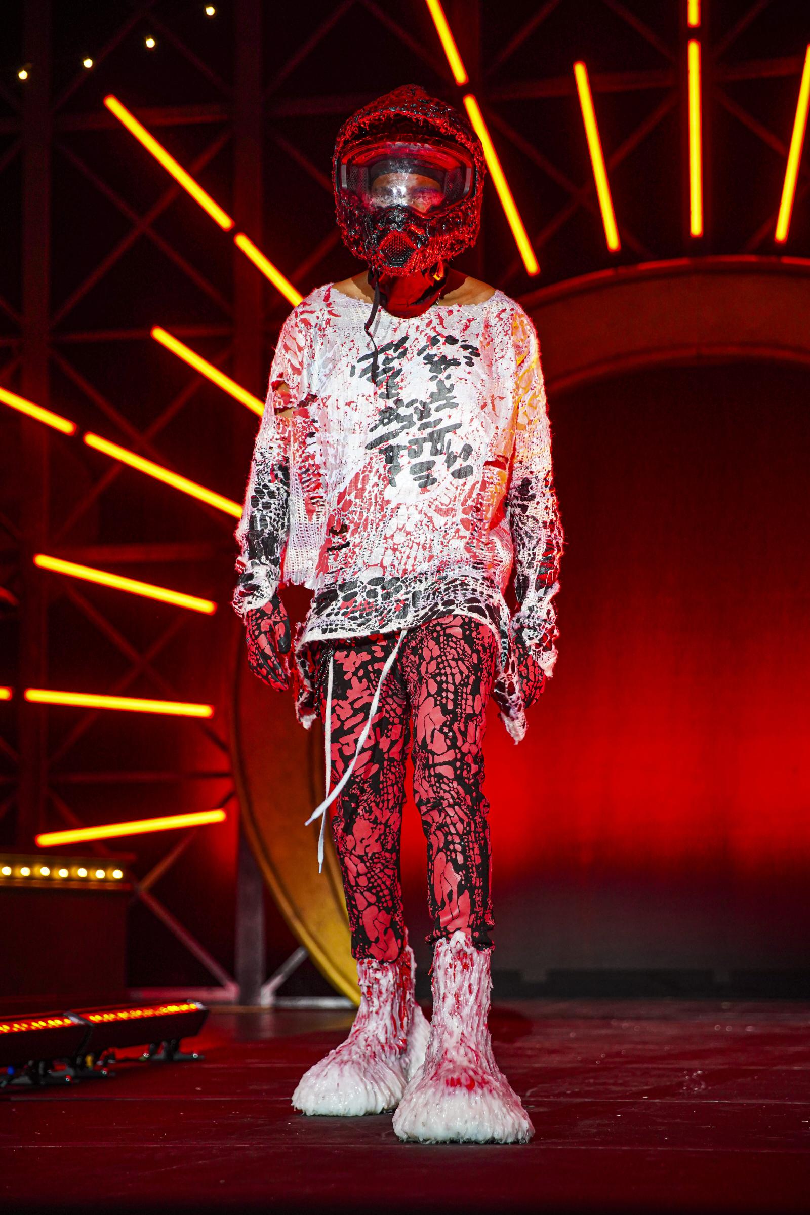 Model in red and white clothing with red lights in background