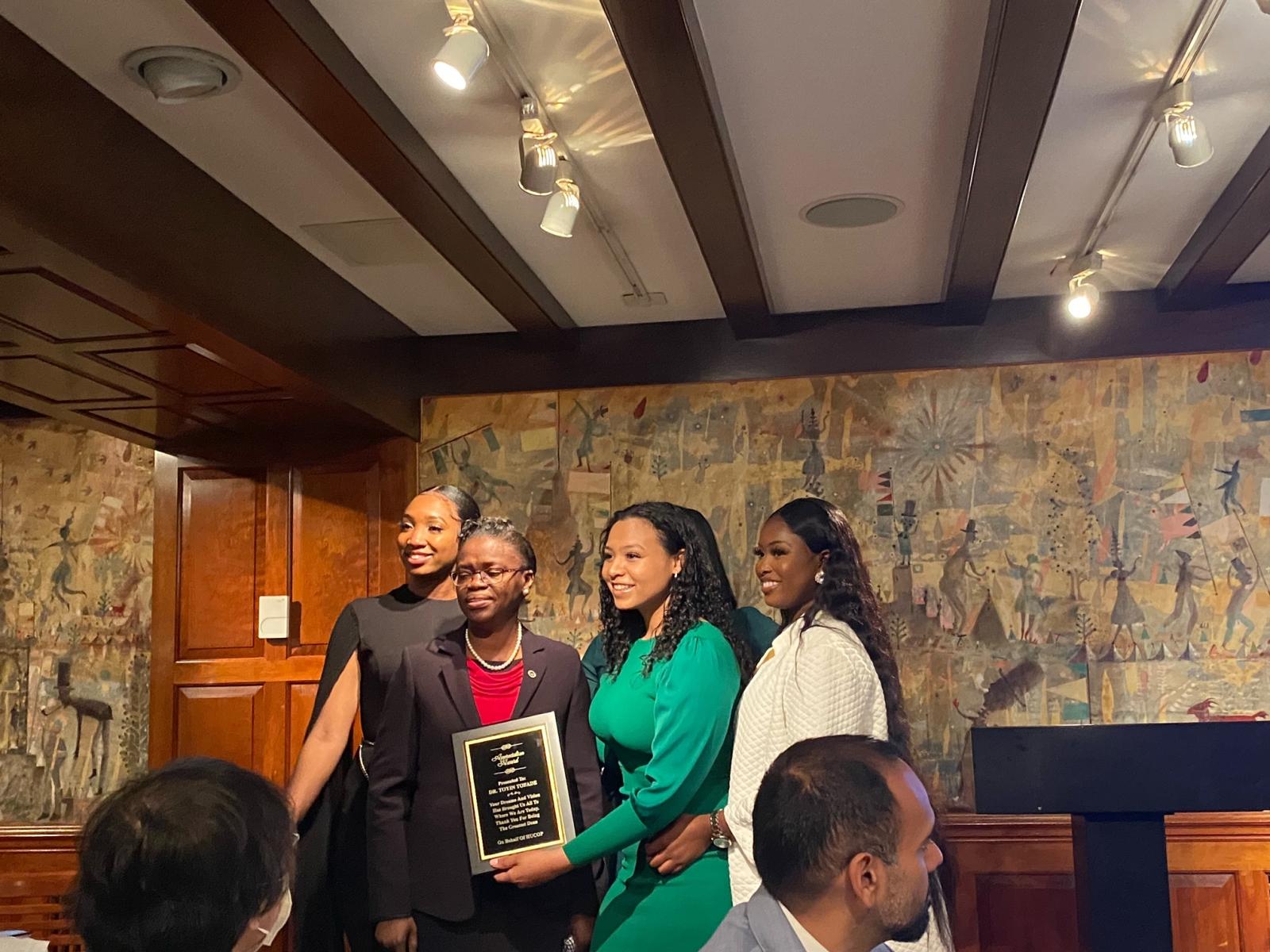 Student leaders present Tofade with a surprise appreciation award during the apothecary brunch.