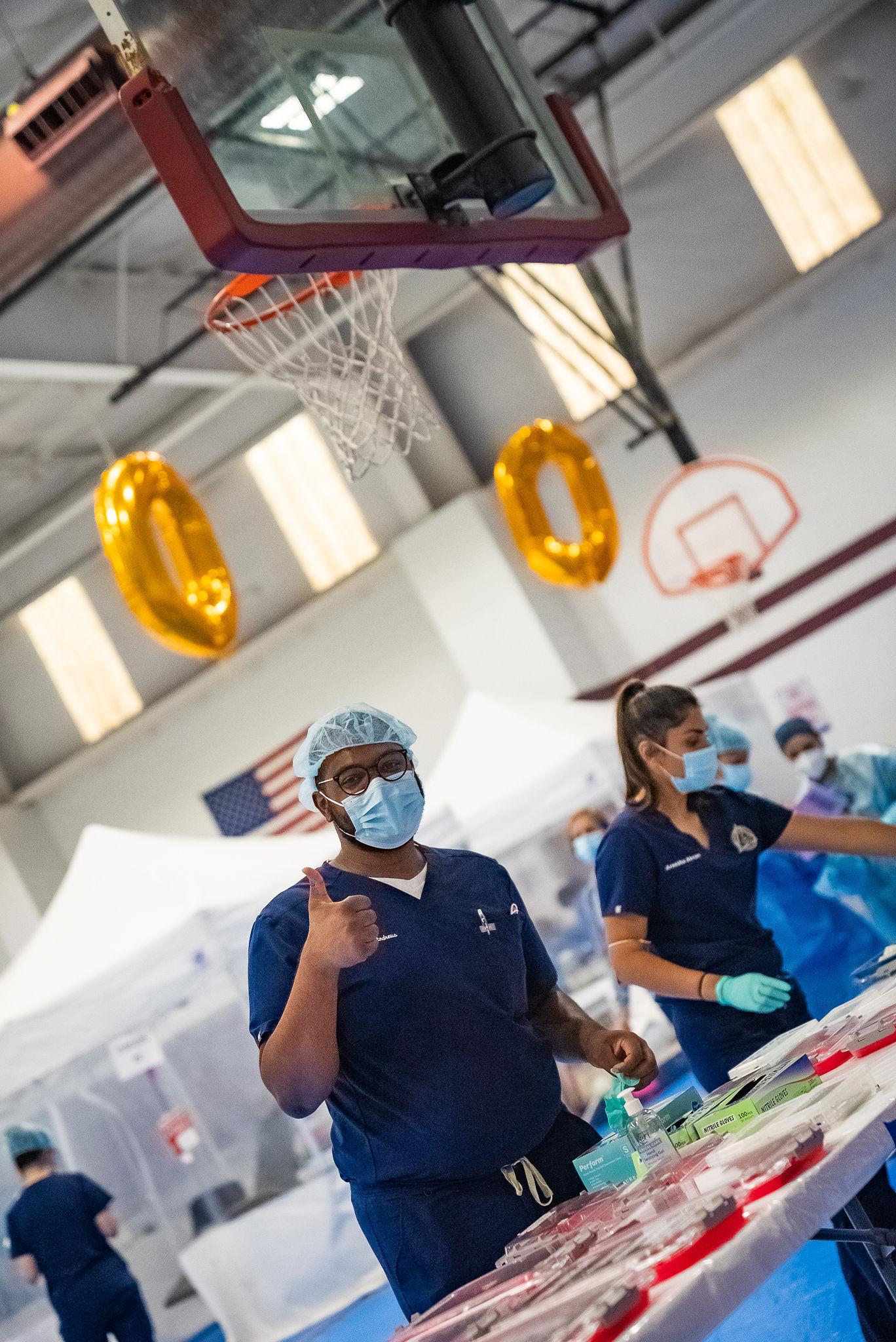 student gives thumbs up at dental clinic