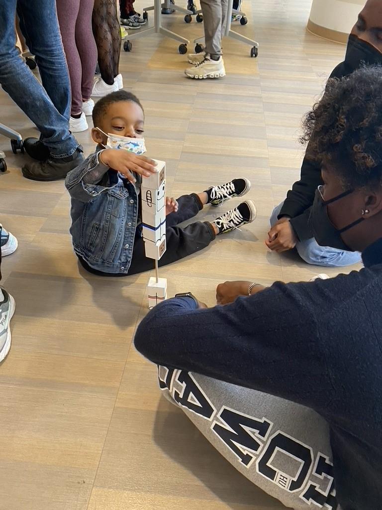 young boy tests a toy