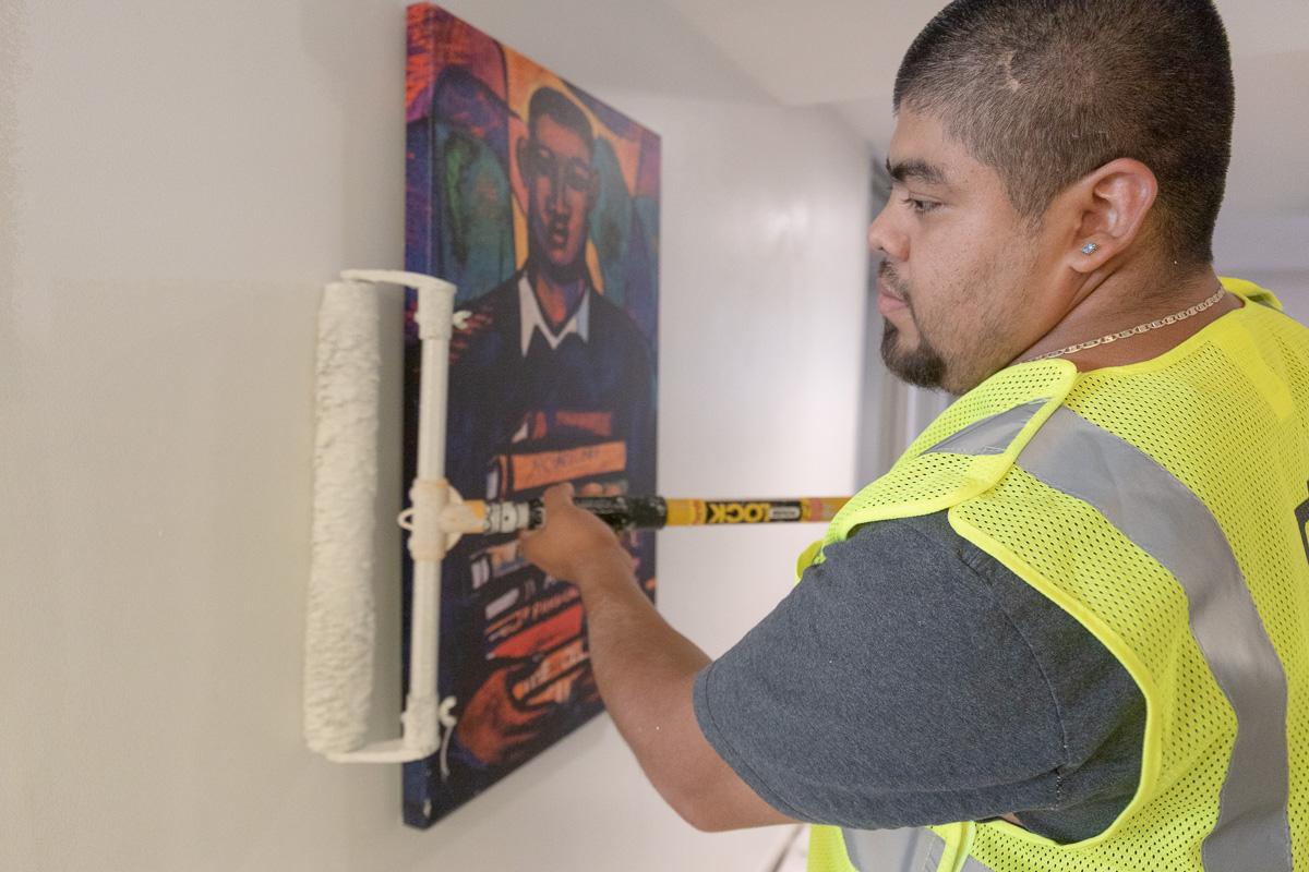 Staff member repaints residence hall