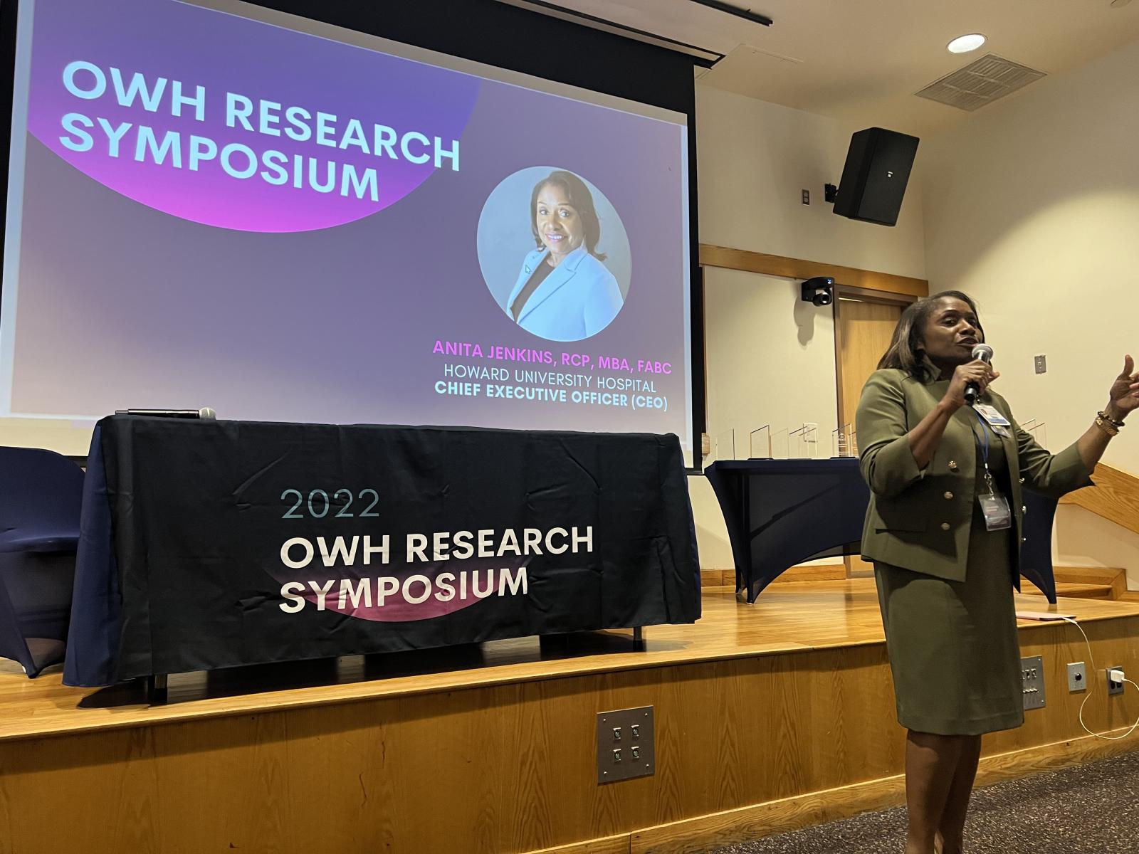 Anita Jenkins speaking in front of screen