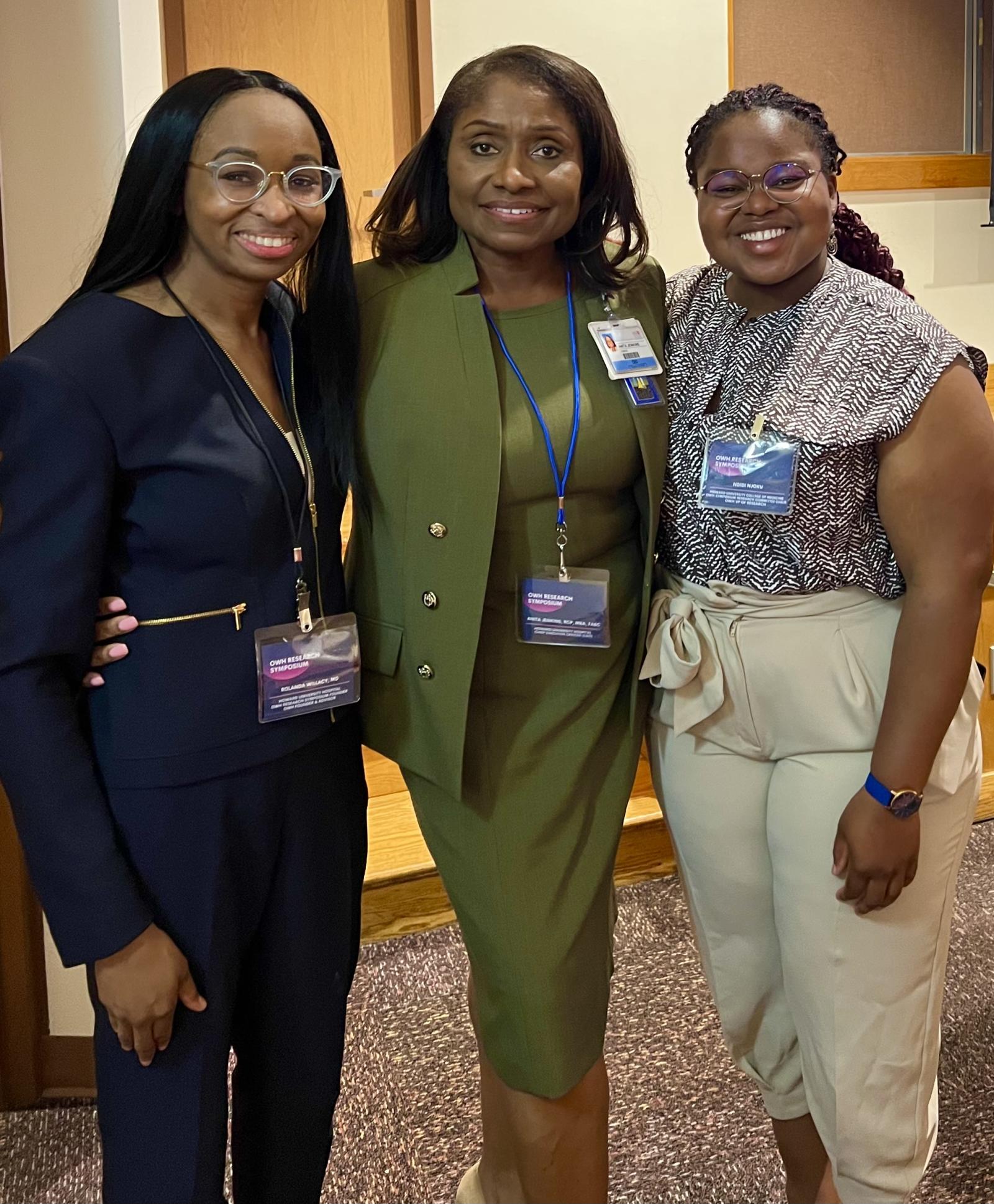 three women standing at a symposium