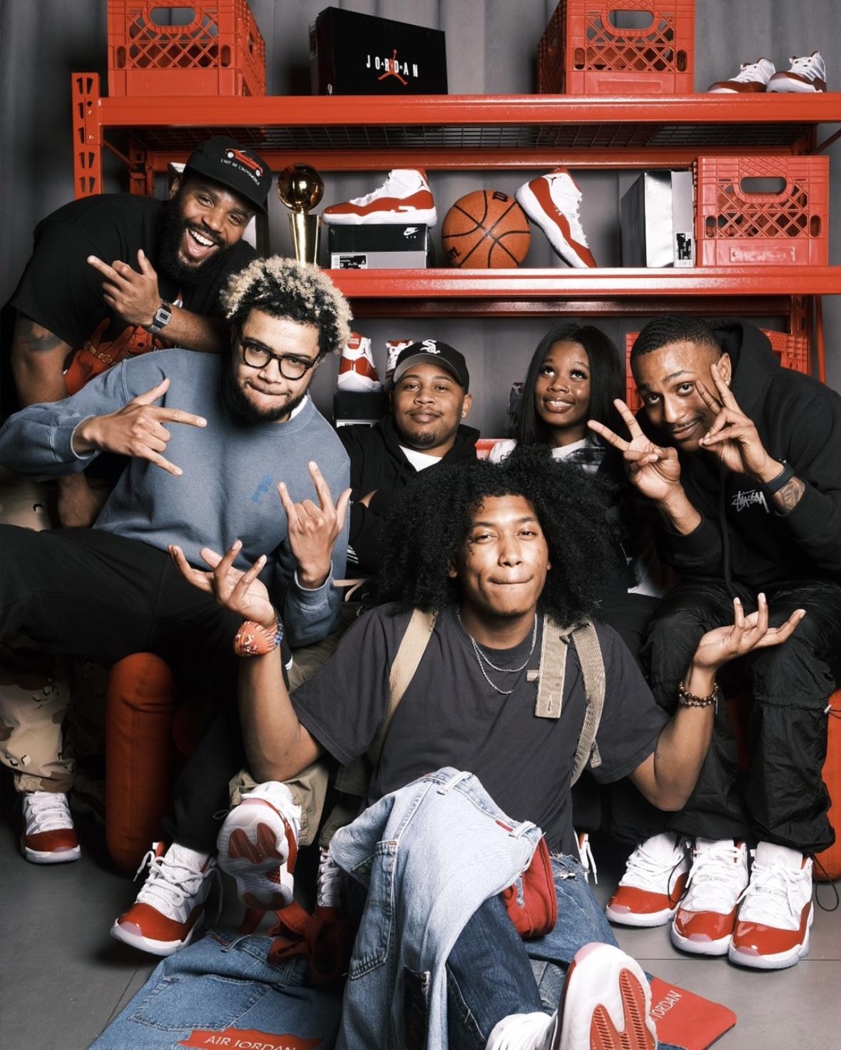 group of students wearing black or gray with red shoes and posing