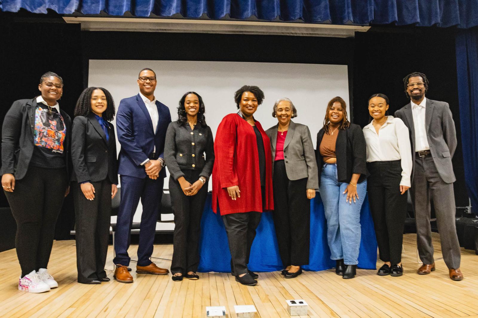 Stacey Abrams poses with student panelists and other supporters
