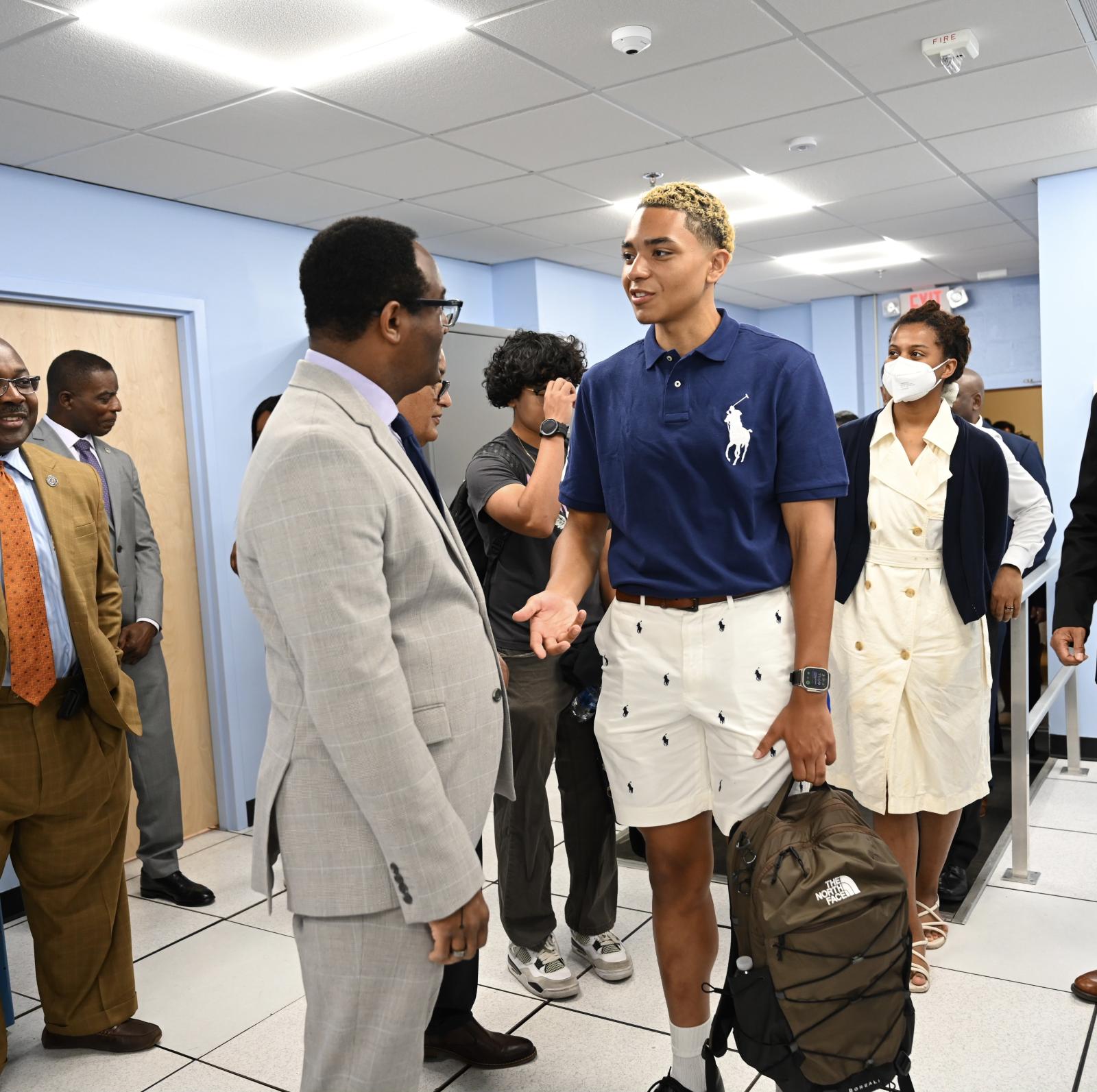 On his third day of classes, freshman Chukundi Salisbury Jr. chats with President Vinson during a tour of the new post-validation silicone lab. (Source: Howard University)