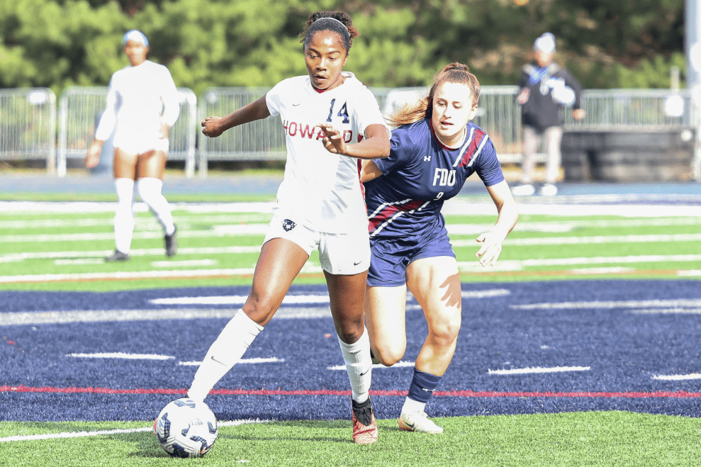 Howard Women's Soccer player kicks ball.