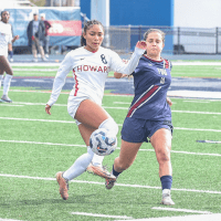 Howard Women's Soccer player with ball.