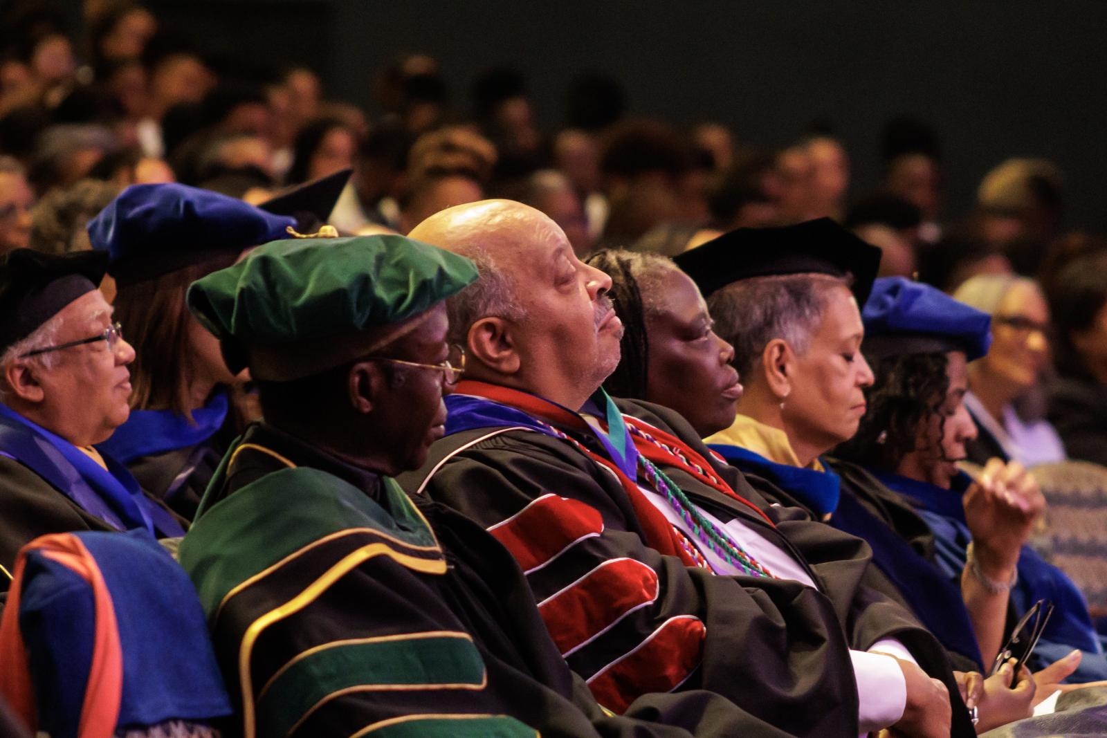 Howard University faculty from diverse ethnicities and genders wearing academic regalia