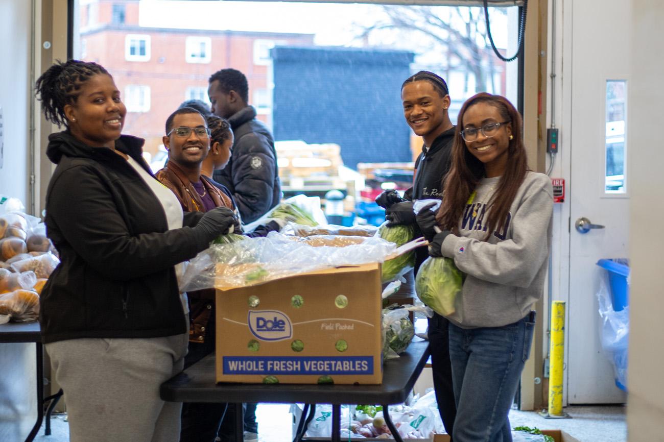 Students help load fresh food in boxes in Washington, DC