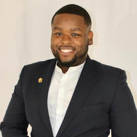 A professional headshot of Lennox Cowan