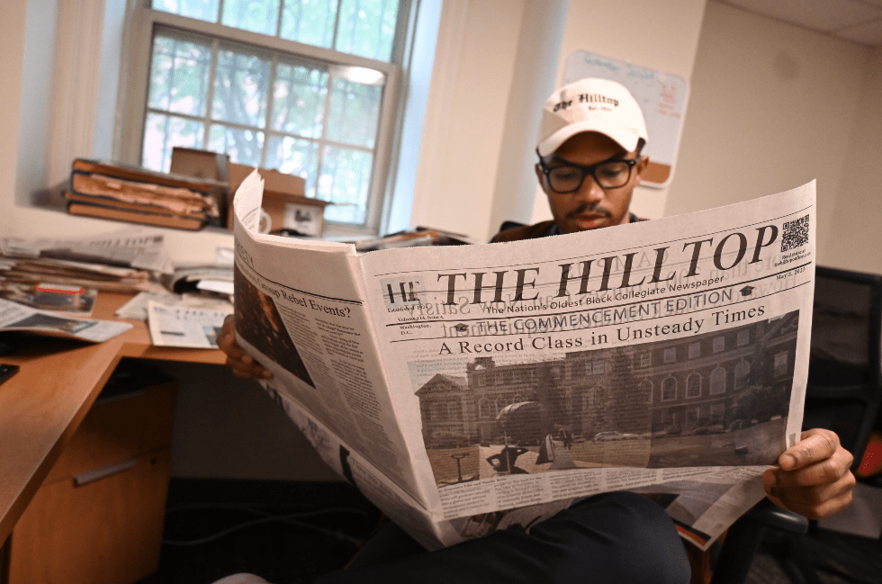 JD Hilltop editor reading the paper