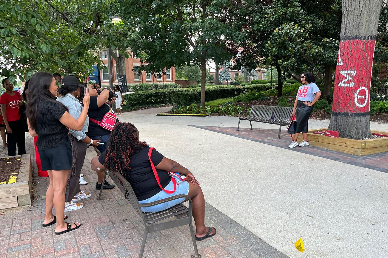 Members of Delta Sigma Theta visit a marked tree on Howard's campus.