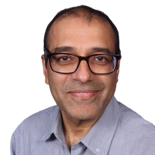 Man wearing a collard shirt and glasses looking into the camera. The background is transparent.
